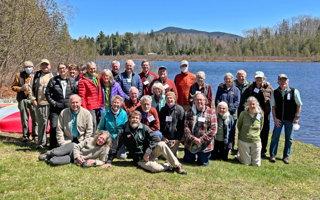 A large group of people in front of a lake