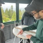 Jas, Sophie, Bill, and Julia learning about how the map would have been used to locate fires (thank you, Bill, for the lesson!)]